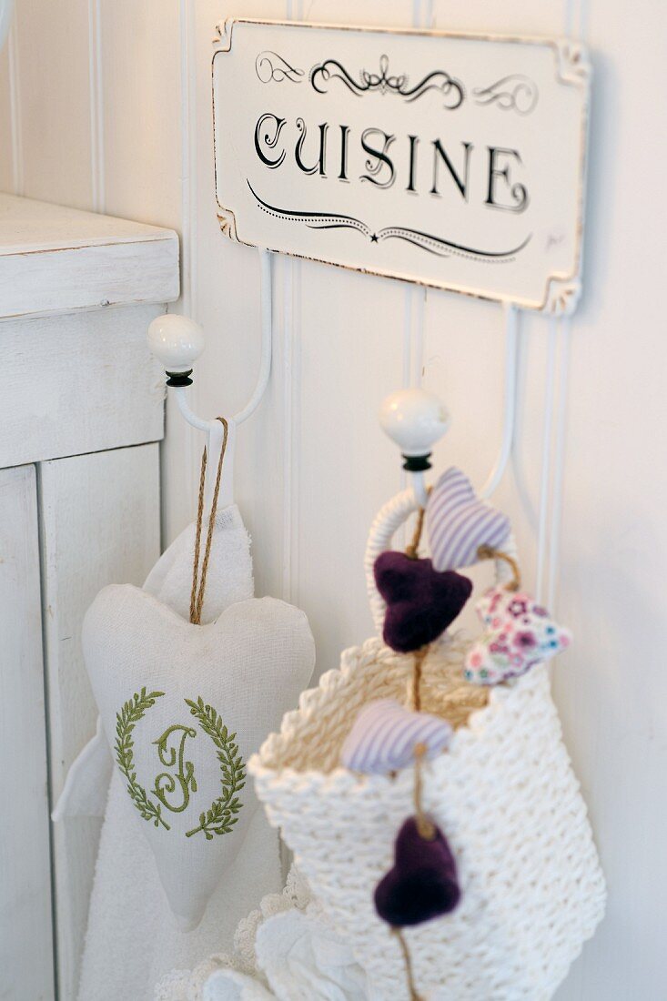 Sign and sachets on hooks in kitchen