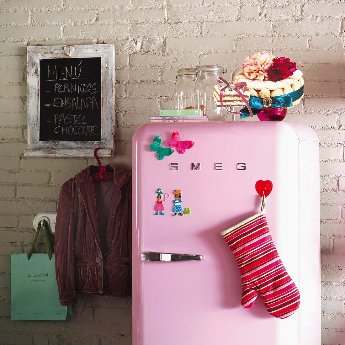 Pink fridge against brick wall