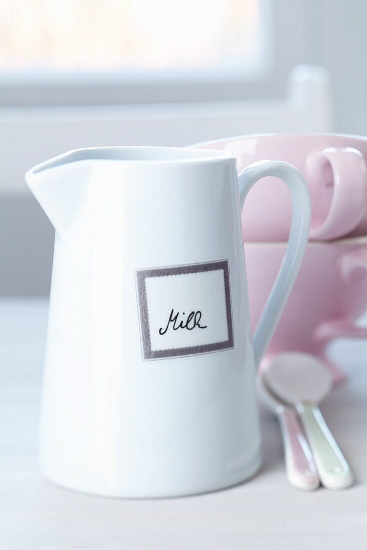 Tape label with handwriting on white milk jug