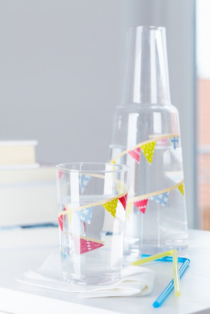 Glass and carafe decorated with tape bunting and matching drinking straws