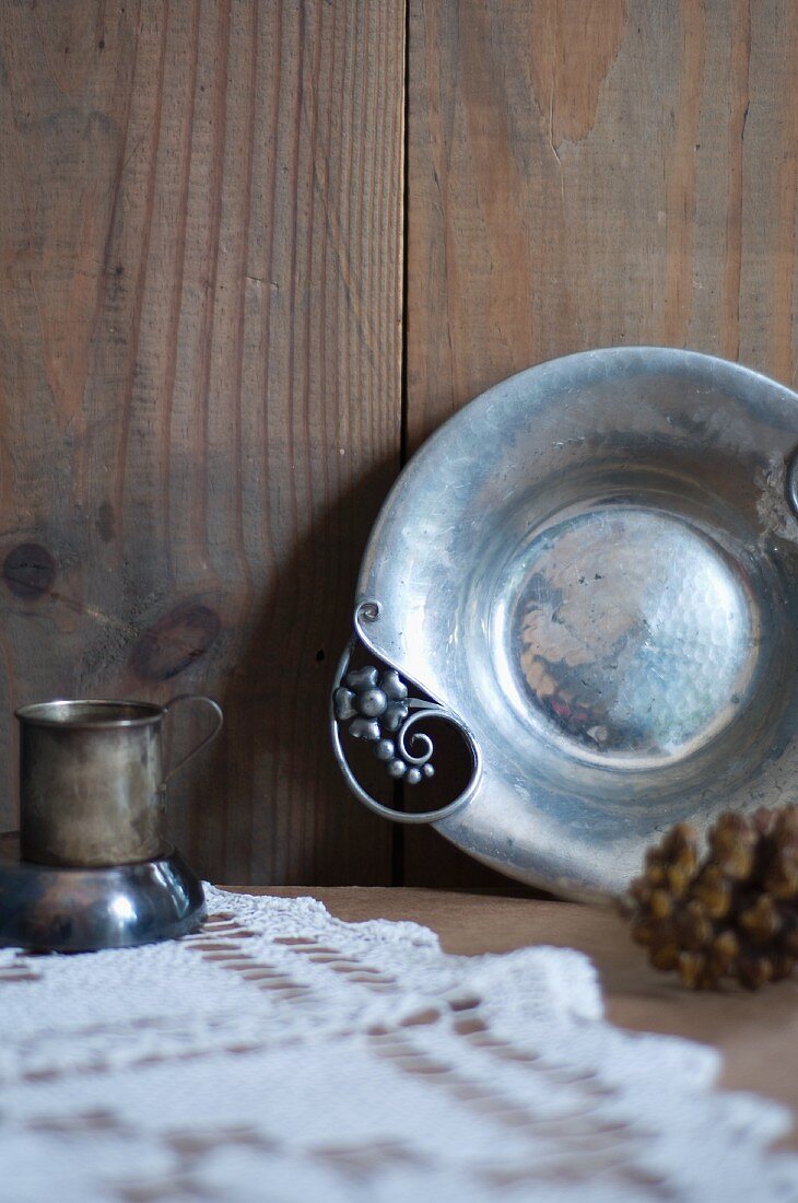 Antique Hammered Metal Dish with an Antique Metal Cup in Rustic Setting