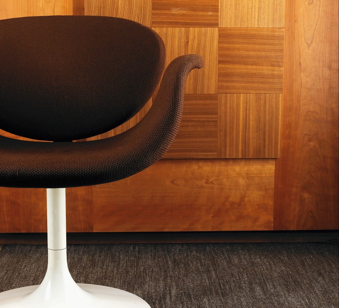 Stuhl mit braunem Sitzpolster und weißem Stuhlbein