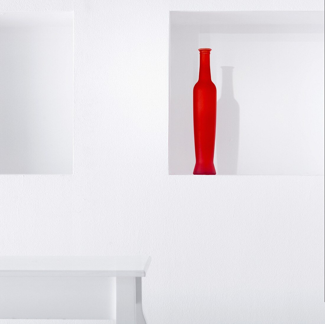 Red vase in wall niche