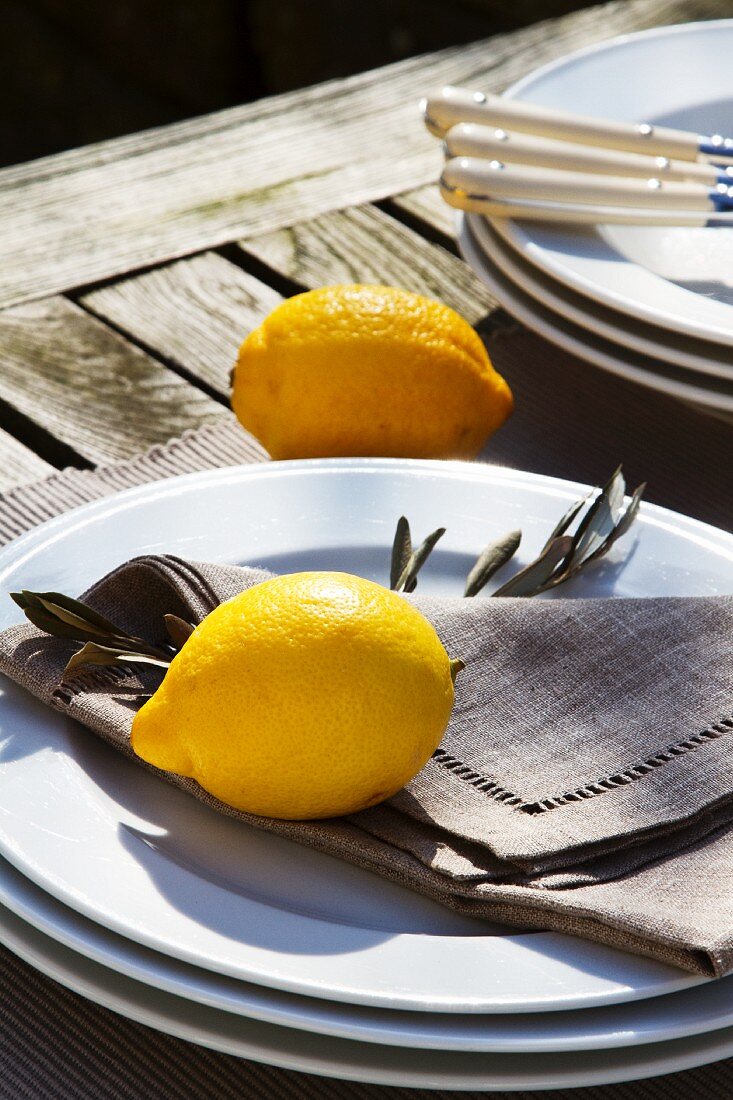 Lemons and stacked plates on rustic table