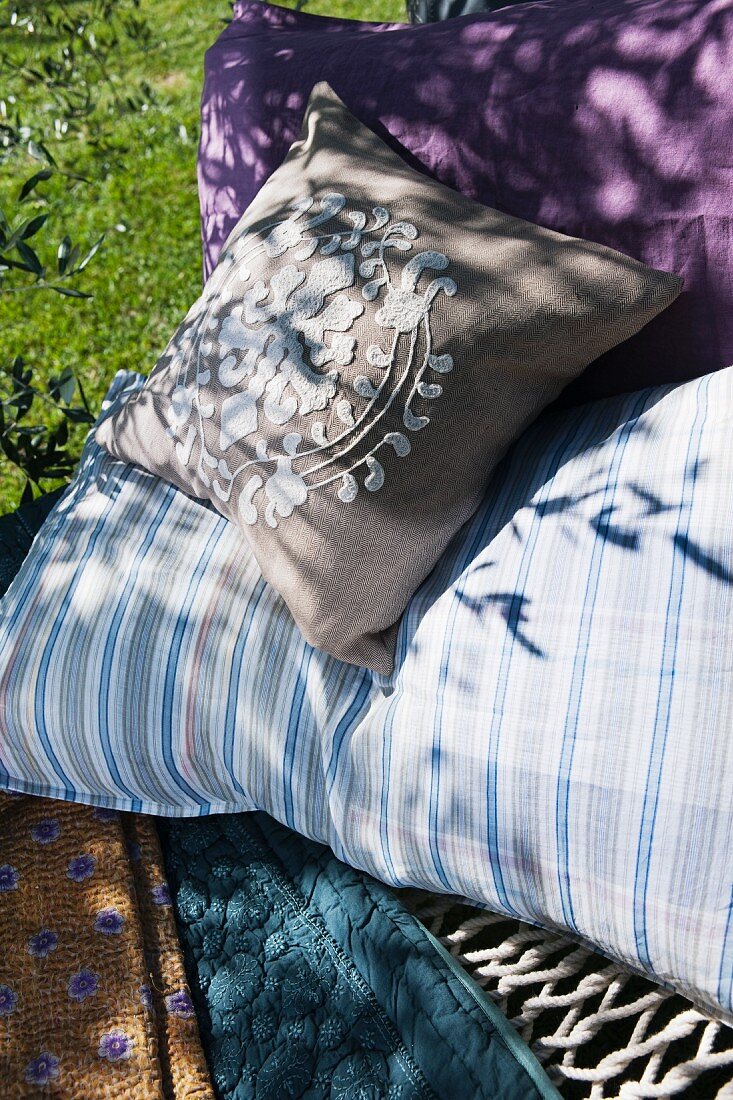 Cushions with different covers lying in hammock