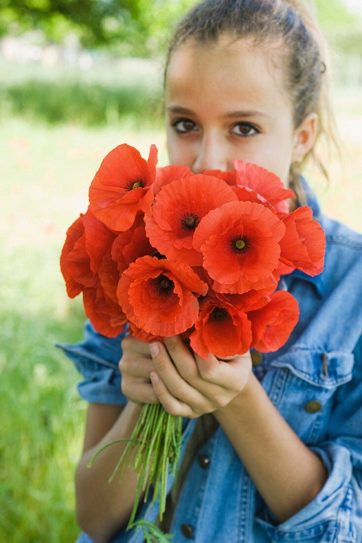Girl with bunch of poppies
