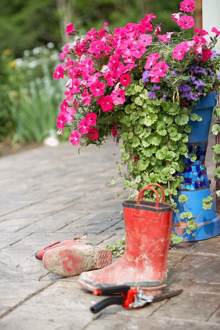 mud boots with flowers in country garden