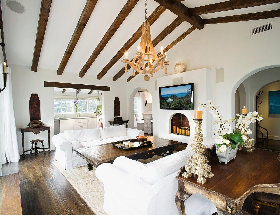 Contemporary living room with ceiling beams and white sofas