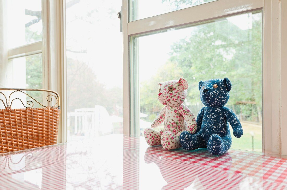 Two hand-made teddy bears in window