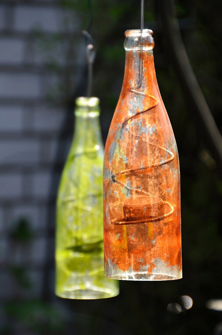 Painted bottles used as lanterns in garden