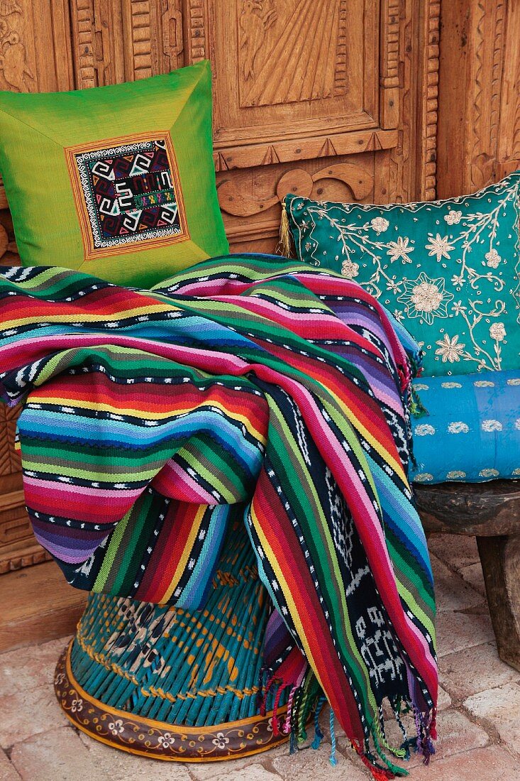 Brightly colored blanket and decorative pillows