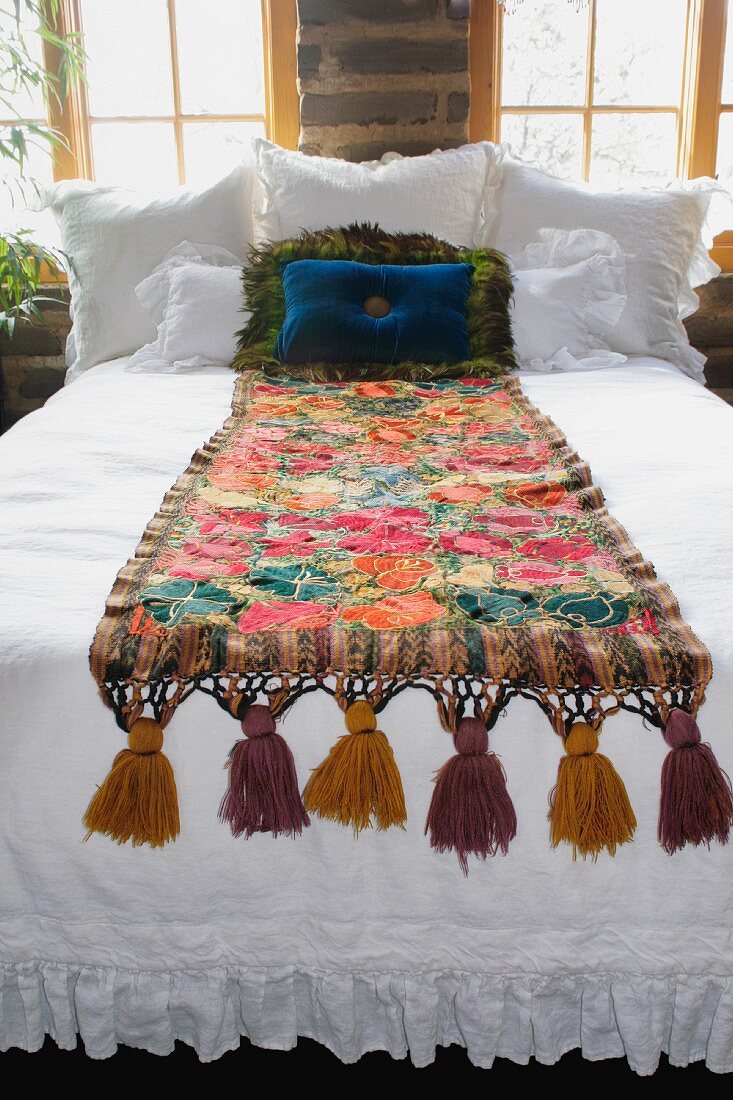 Bed runner and throw pillows on bed