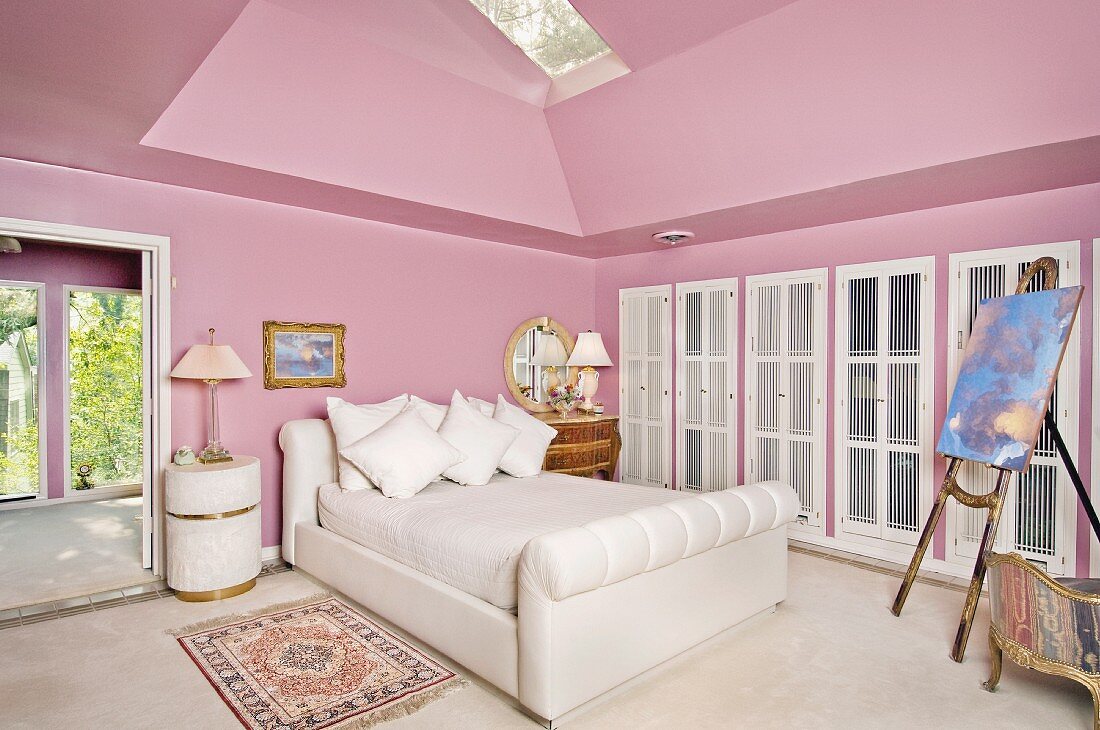 Interior of Pink bedroom with white bed