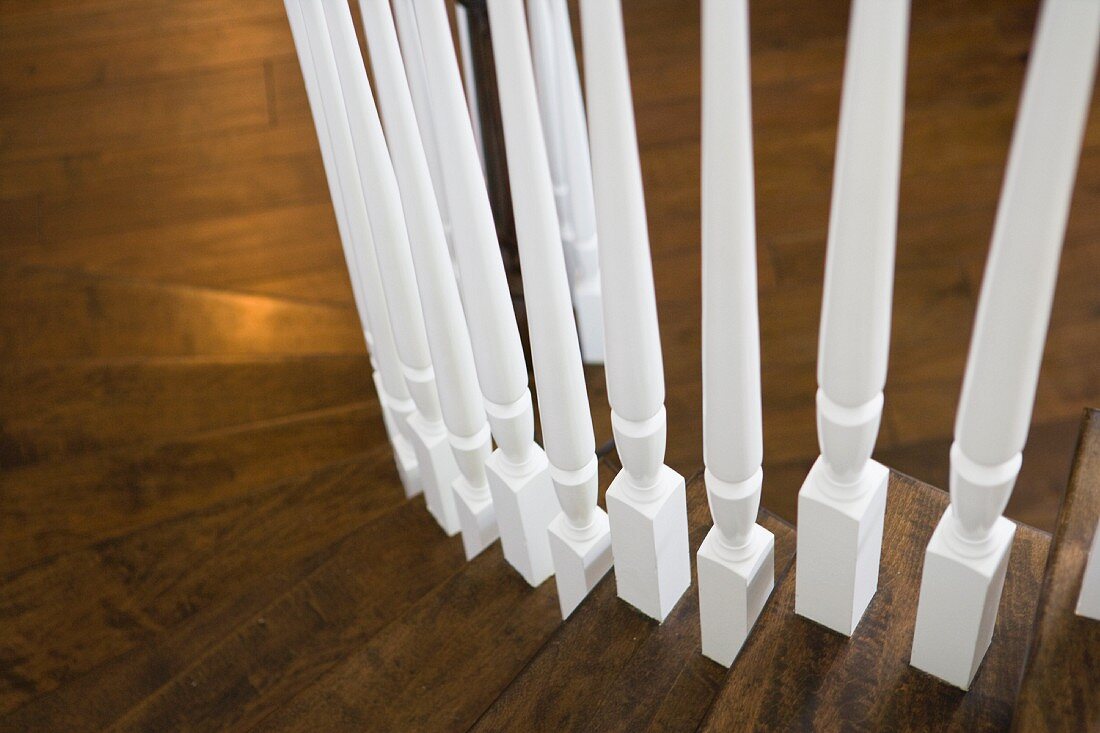 Detail white spindles of staircase railing