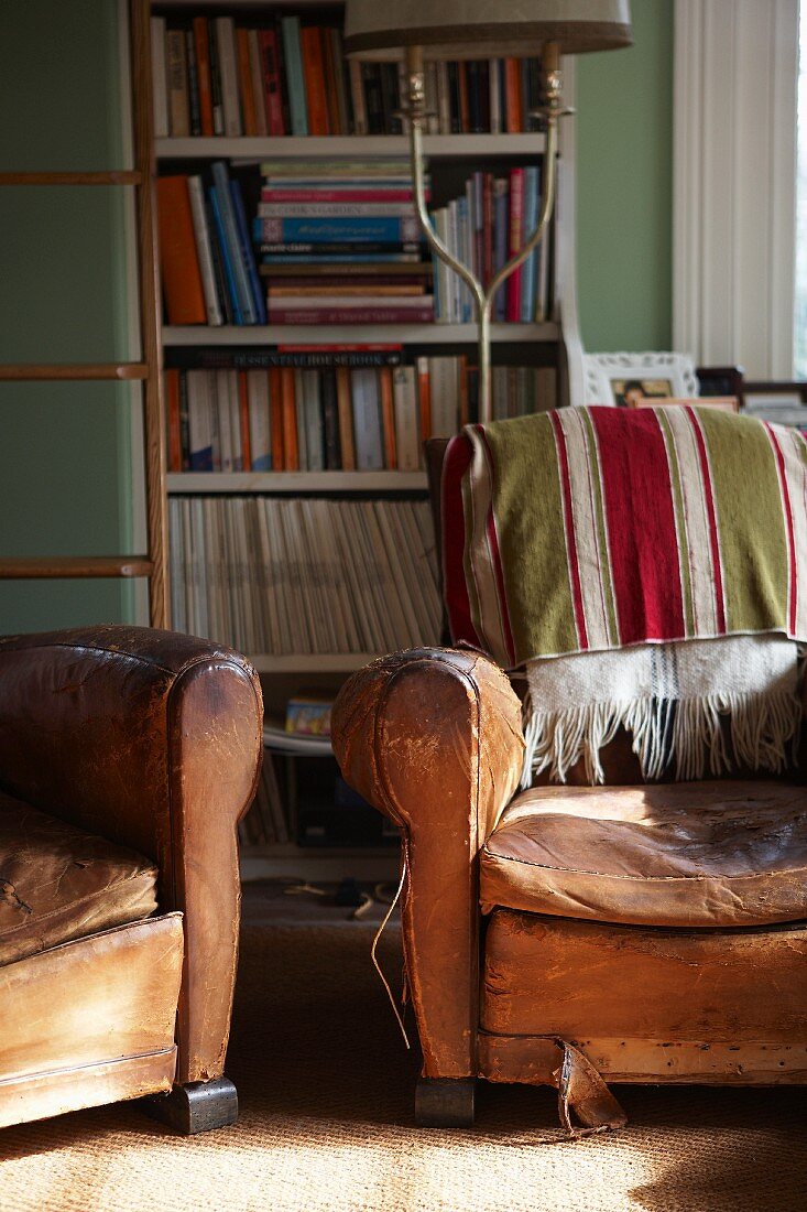 Chairs with leather upholstery in front of bookcase