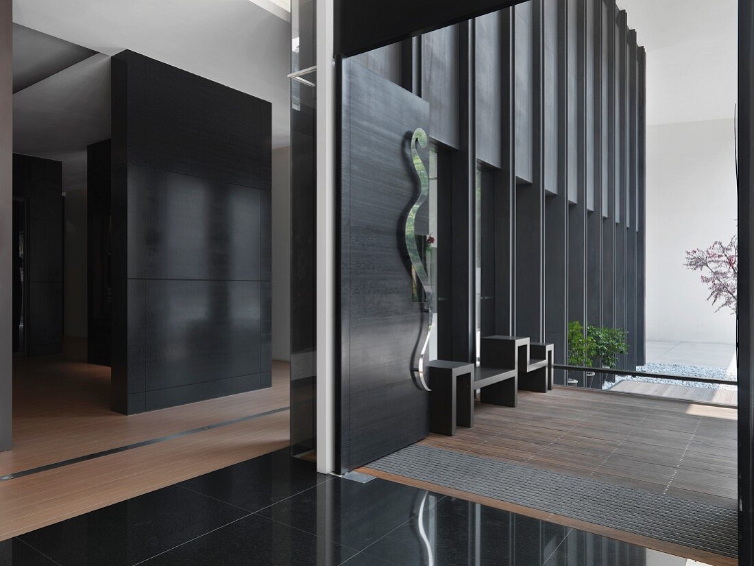 Offene Funktionsbereiche mit verschiedenen Bodenbelägen in minimalistischer Wohnung