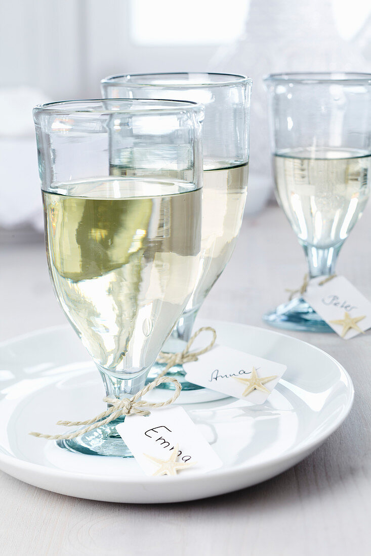 Name cards tied to wine glasses