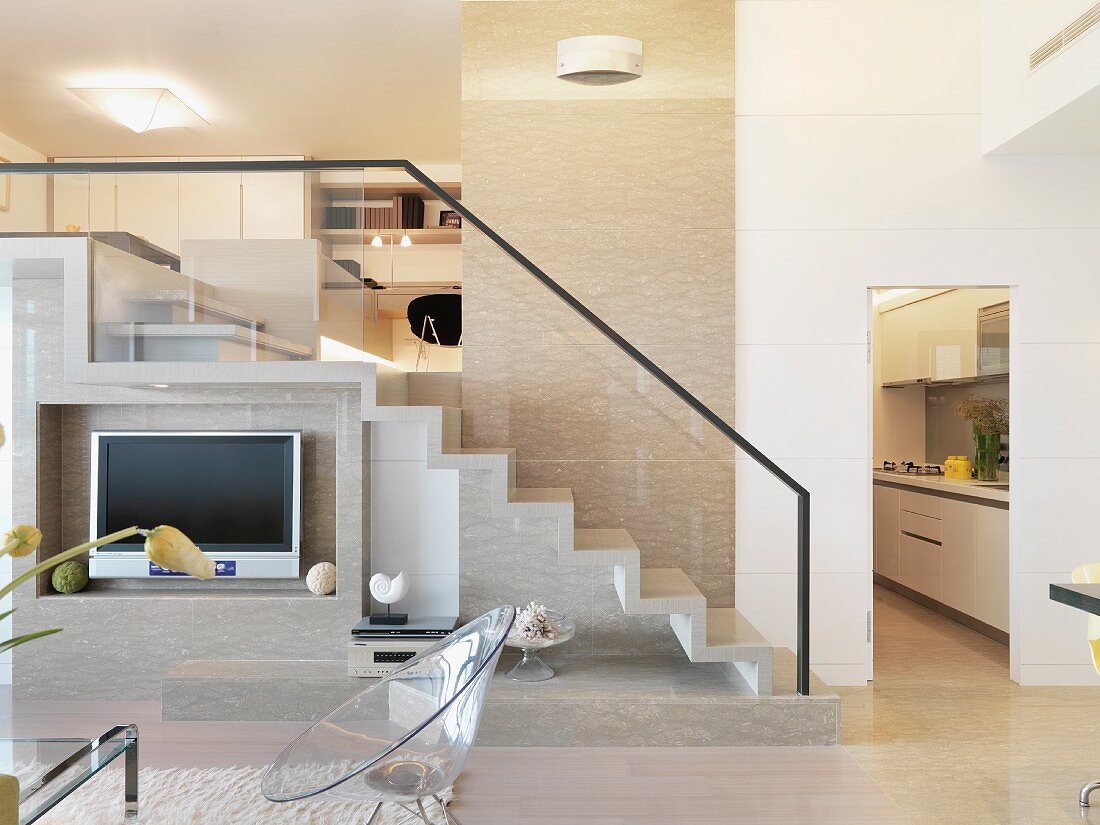Fernseher in Nische vor Treppenaufgang in offenem, modernen Wohnraum