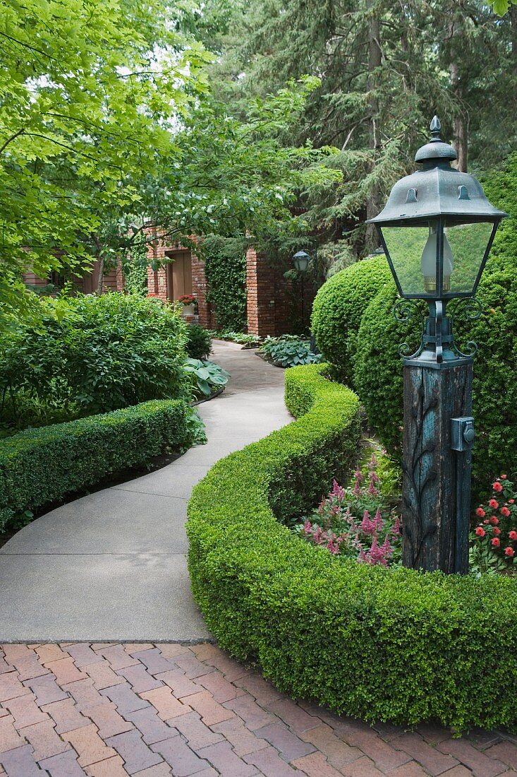 Curved garden patch with lantern