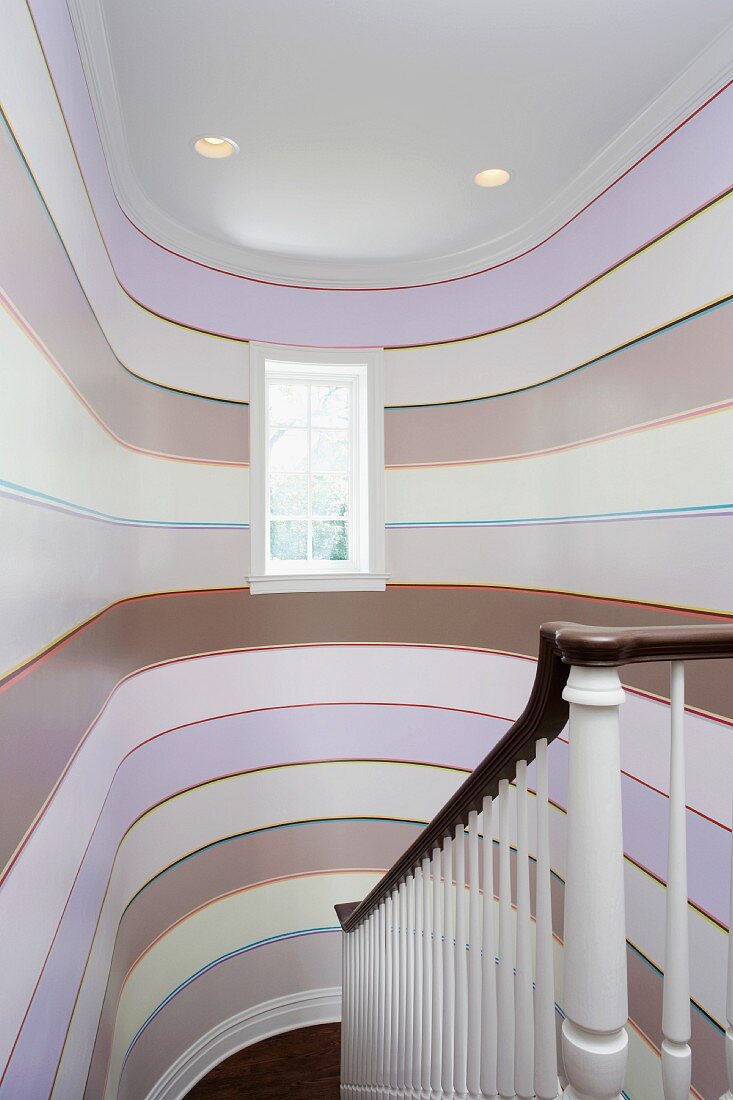 Stairwell with pattern of stripes on curved walls