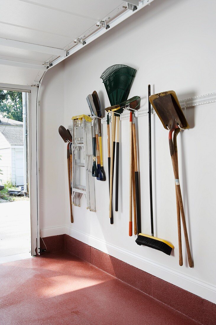 Gardening utensils hanging on garage wall