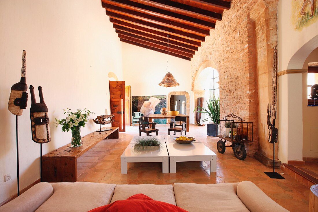 Offener Wohnraum in mediterranem Landhaus mit modernen und rustikalen Möbeln im Mix
