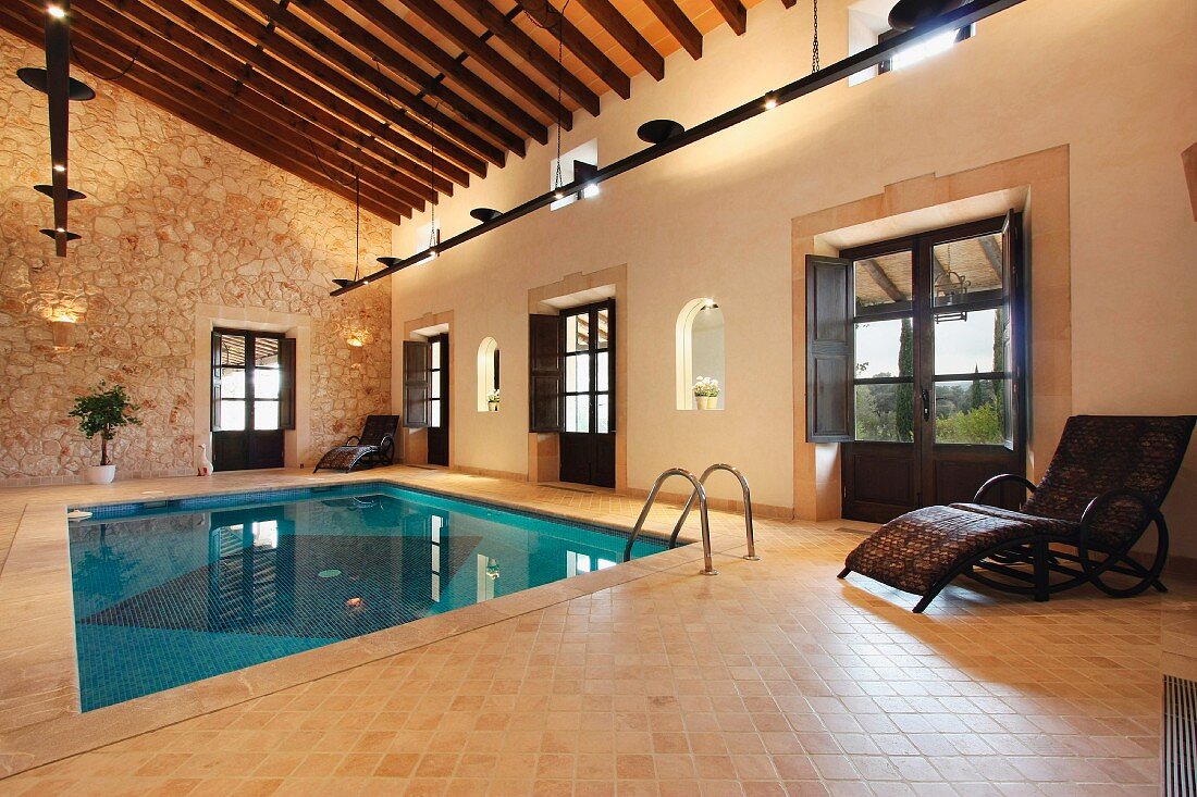 Indoor Pool in mediterranem Landhaus mit Natursteinwand