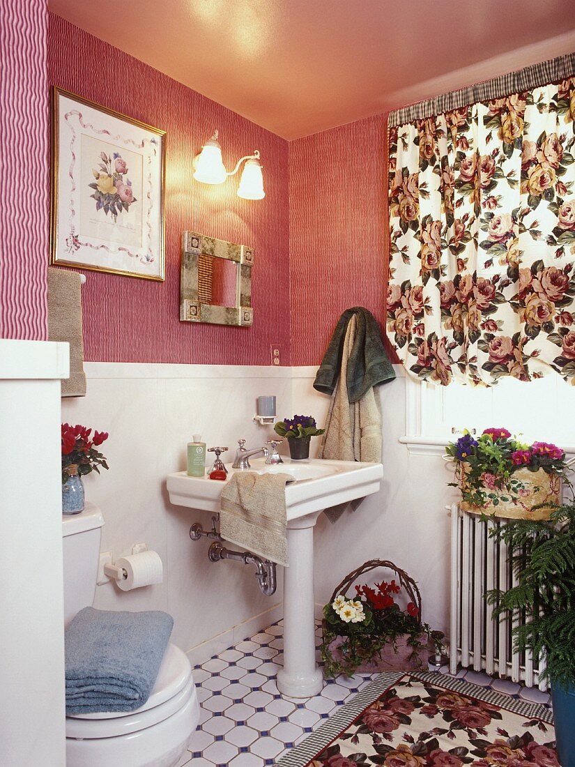 Bathroom with pink moiré wallpaper and floral curtain and rug