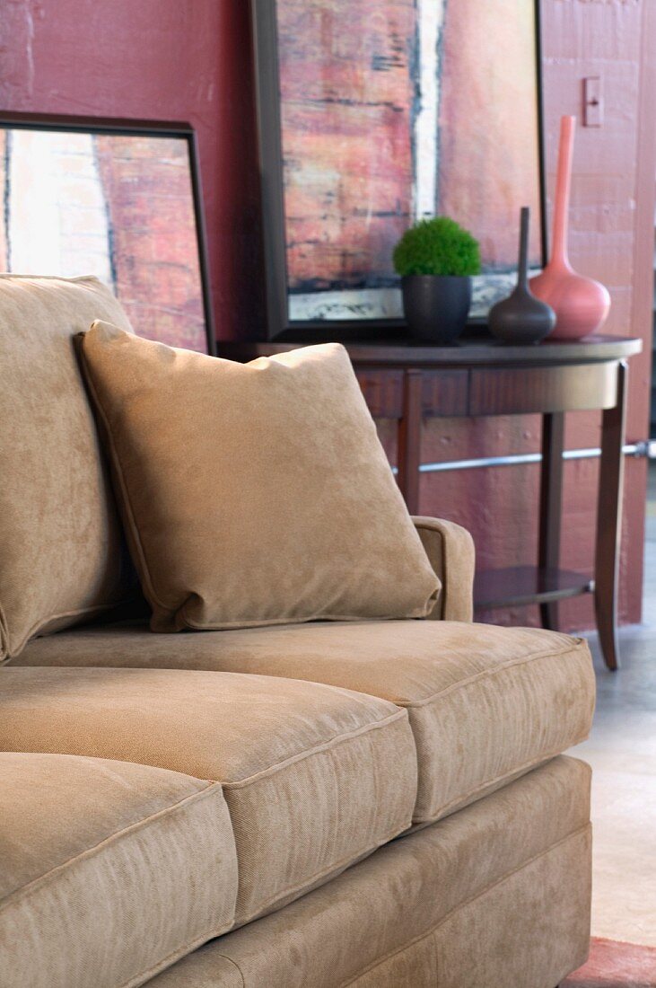 Detail tan sofa with throw pillow