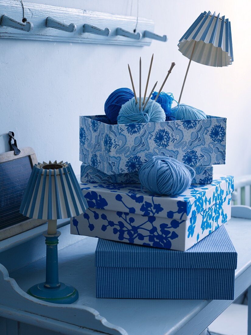 Old shoe boxes covered with blue and white fabric as organizers