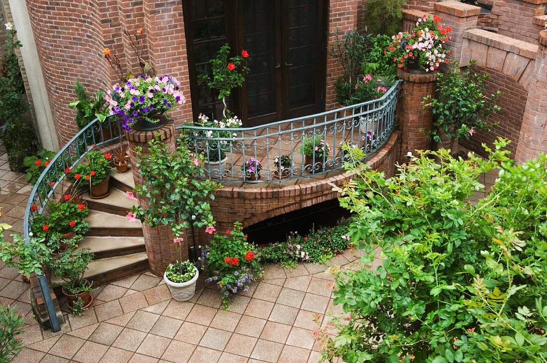 Courtyard with terrace and steps leading to brick house