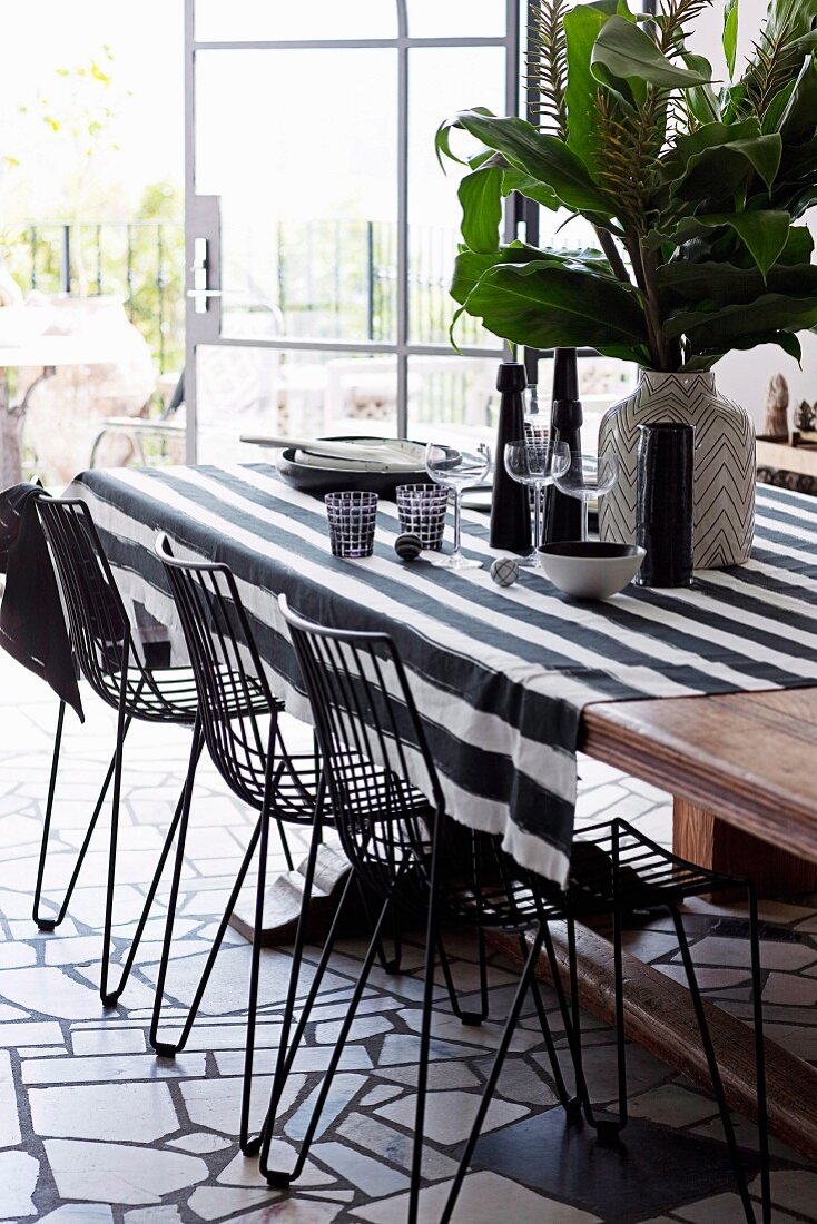 Graphic pattern mix at the dining table with a striped tablecloth