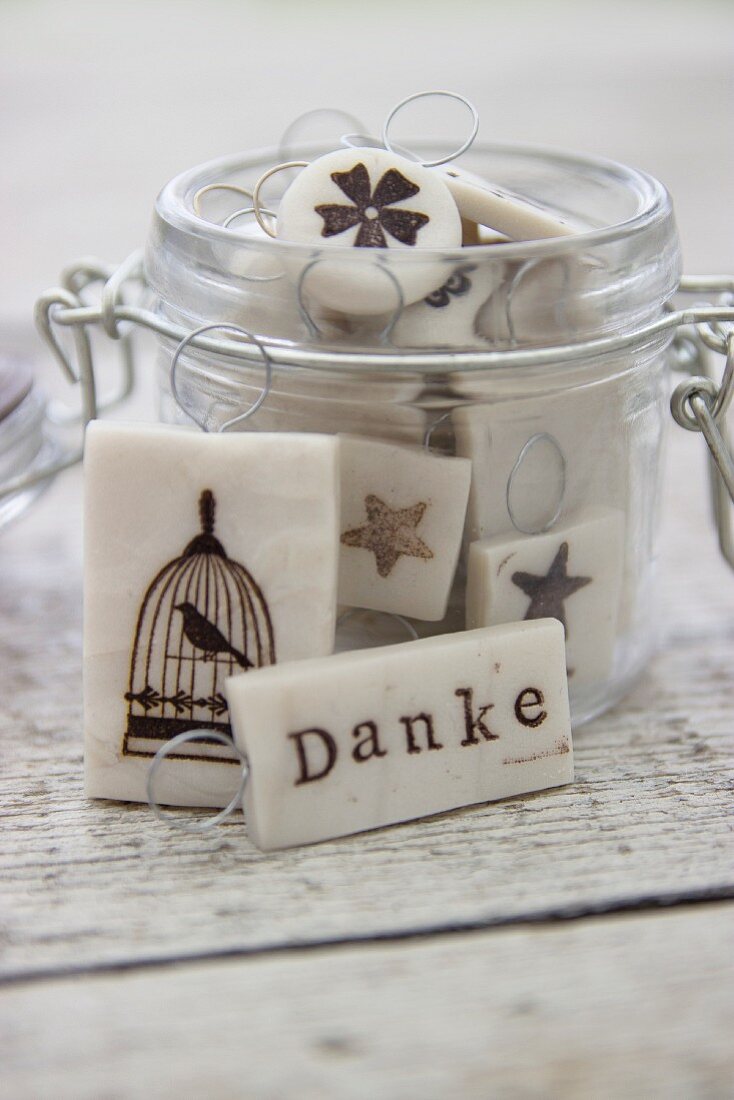 Hand-made polymer clay gift tags in storage jar