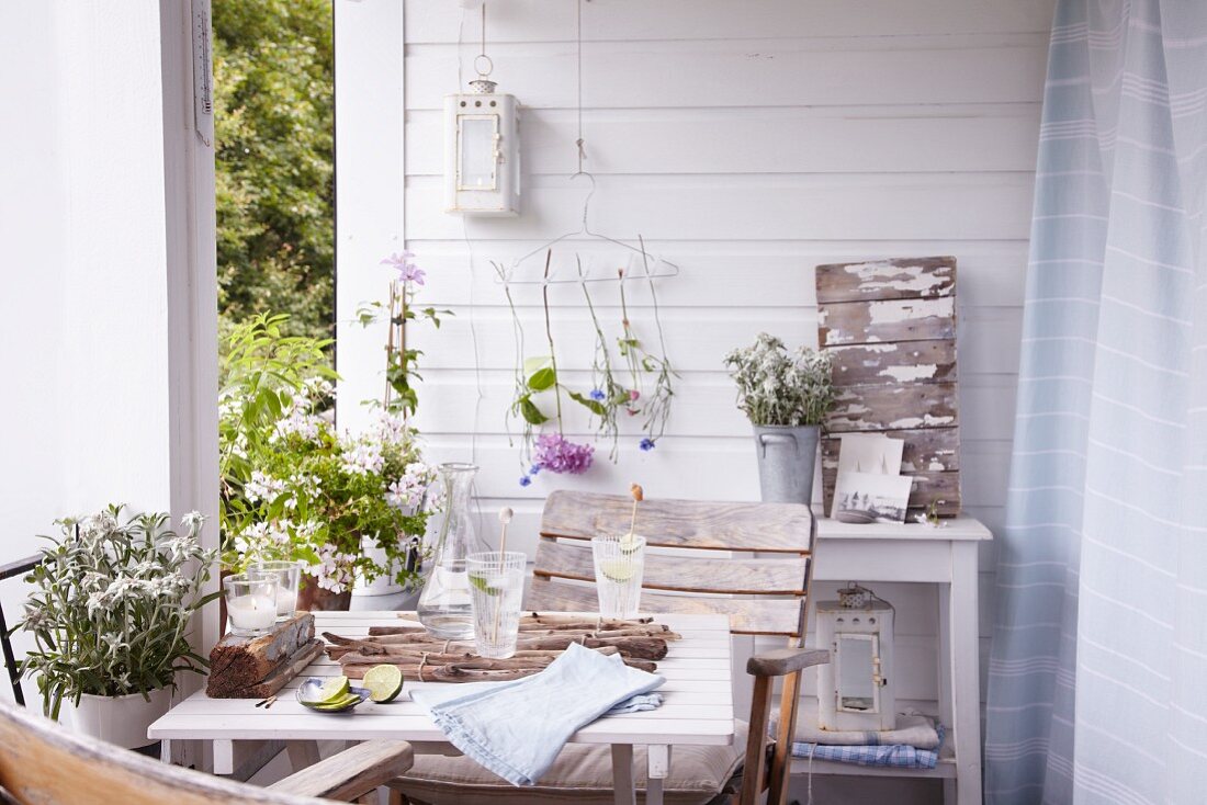 A summery table decorated with flowers and natural treasures on a terrace
