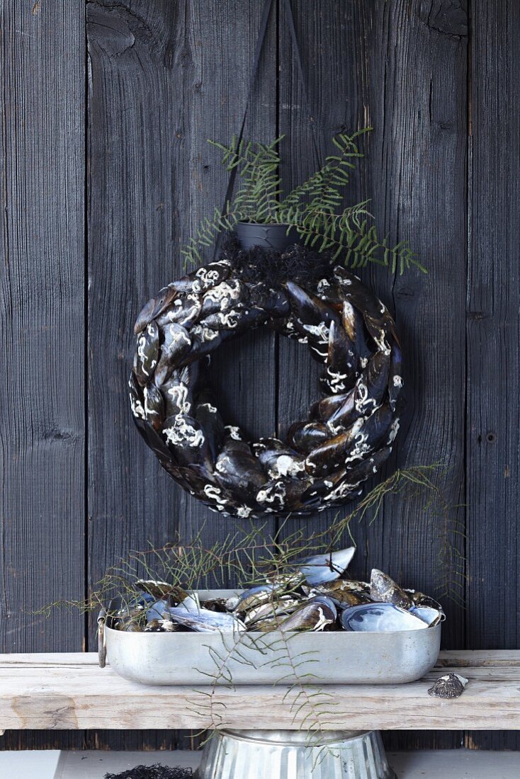 A wall wreath made of mussel shells and coral as maritime decoration