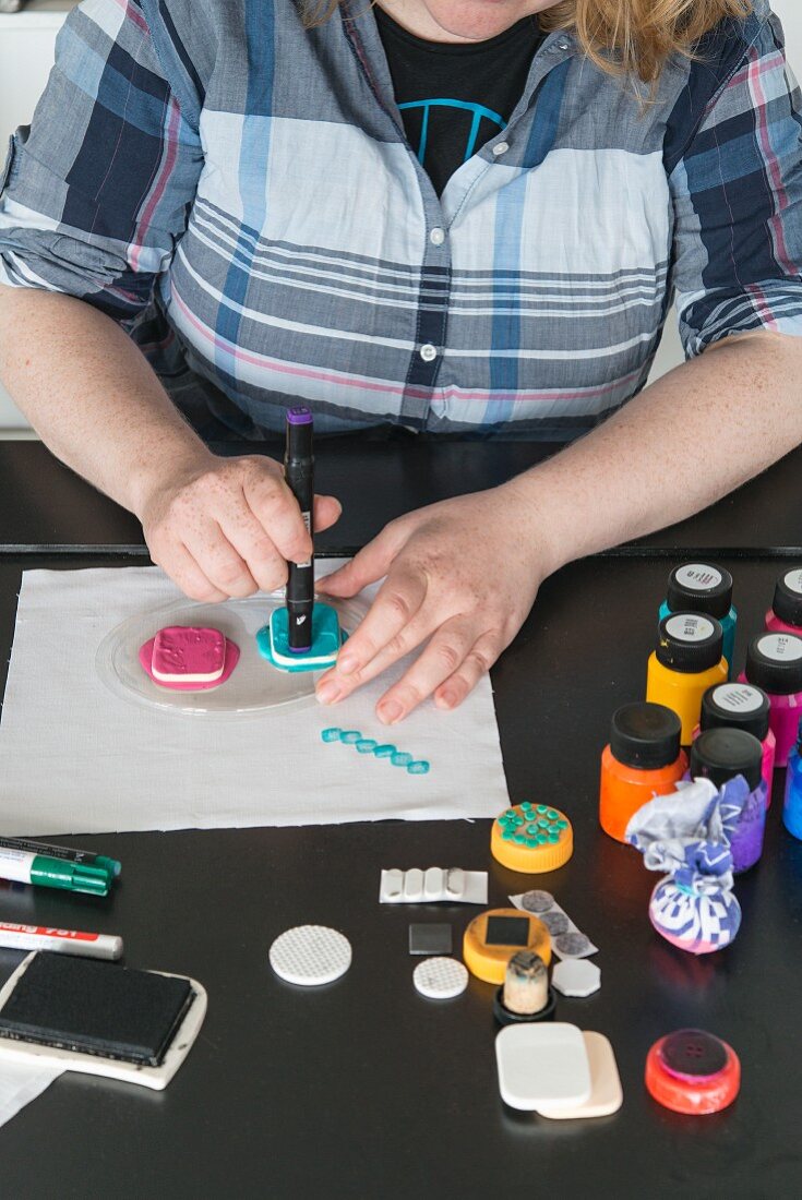 Pen caps being used as stamps for printing fabric