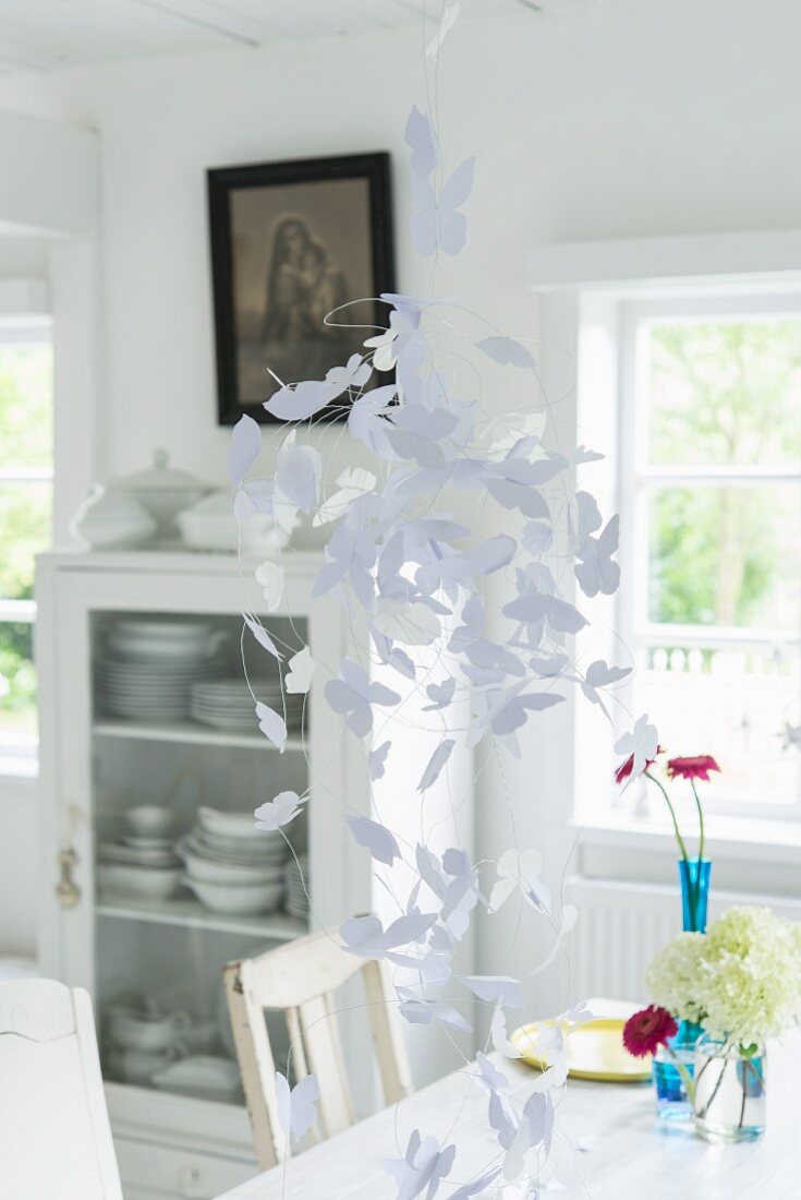 White paper butterflies hanging from the ceiling
