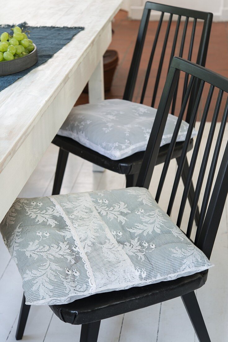 Homemade chair cushions made from white lace fabric