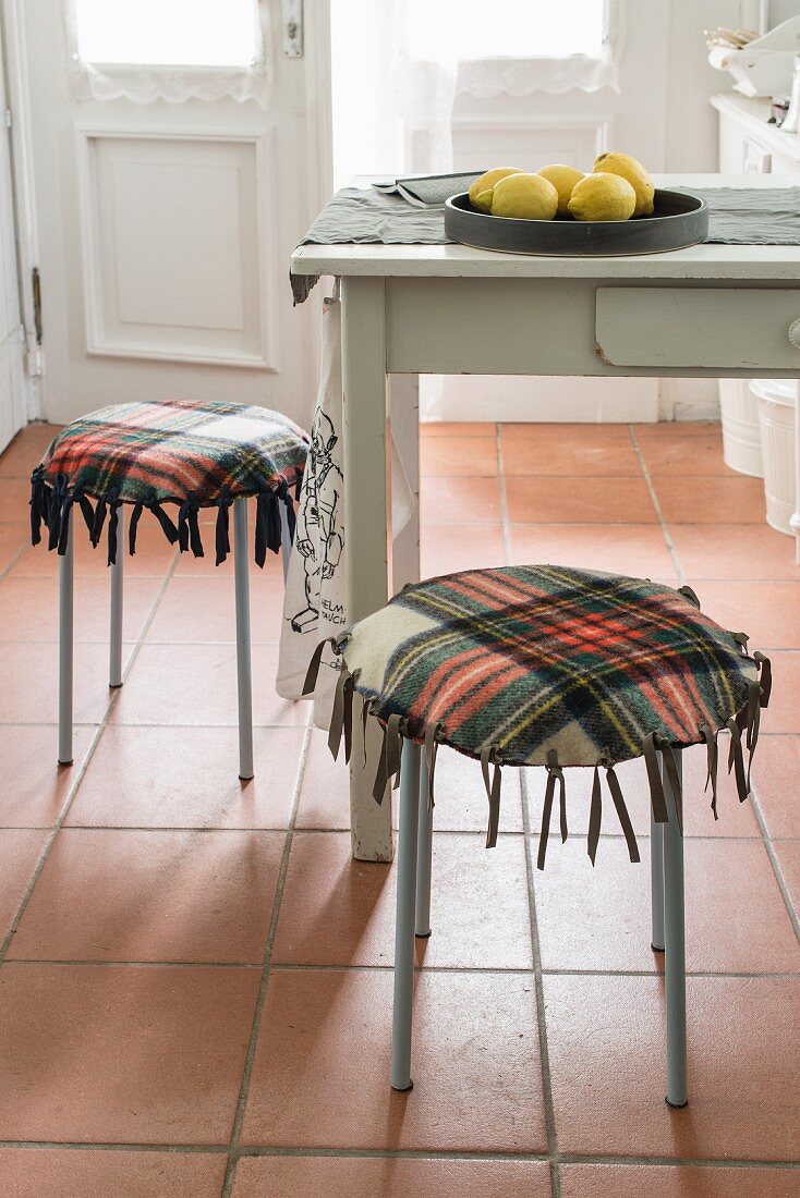 Stools with homemade cushions made from a checked woollen blanket