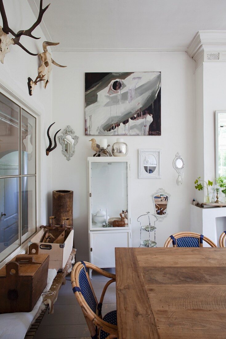 Rustic dining area, white vintage locker and hunting trophies on wall