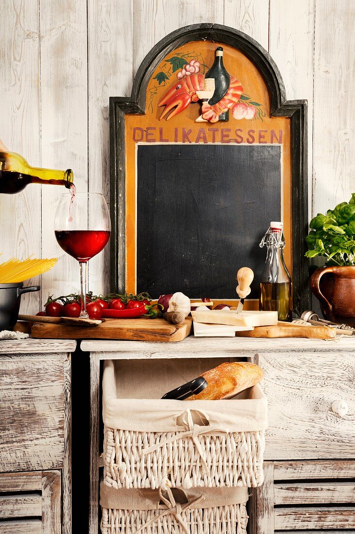 Still-life kitchen arrangement with typical Italian ingredients & chalkboard