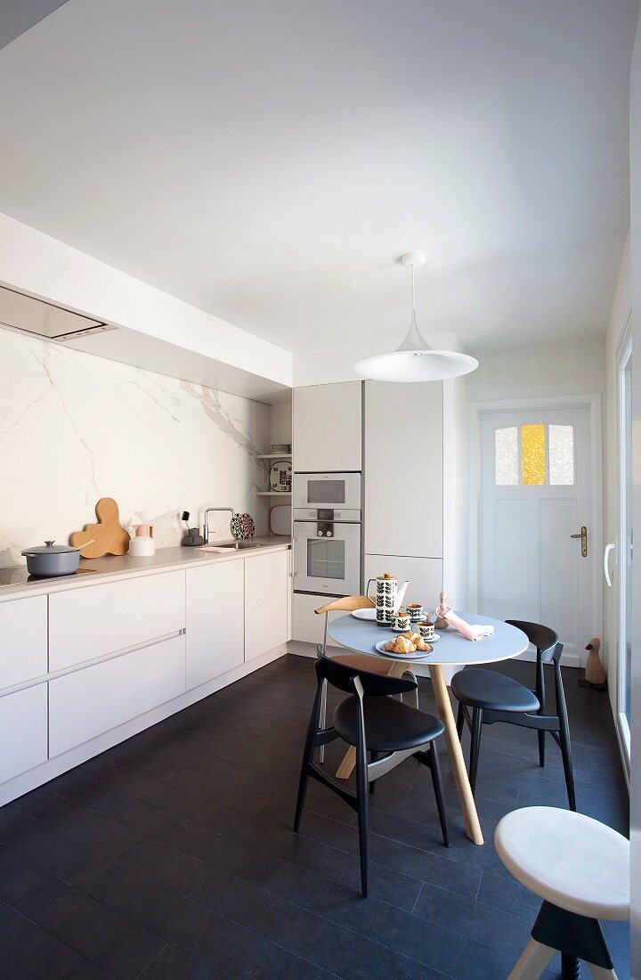 Designer furniture in simple kitchen-dining room