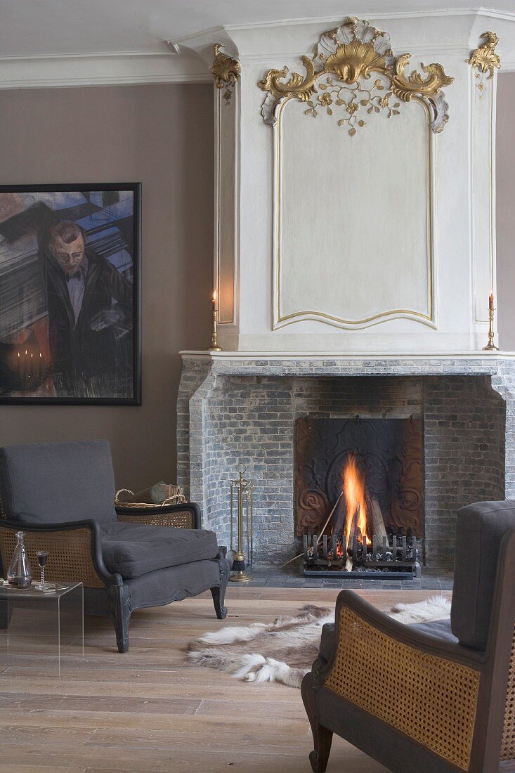 Dark brown armchairs next to fireplace in smoking room