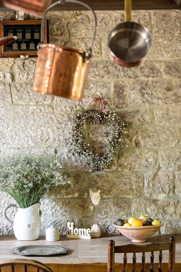 Rustic decorations on table against stone wall