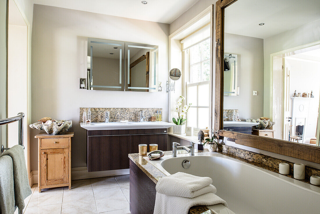 Large mirror on wall above washstand in bathroom