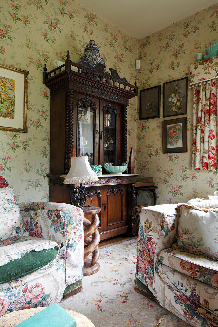 Worn floral sofas in an old-fashioned living room