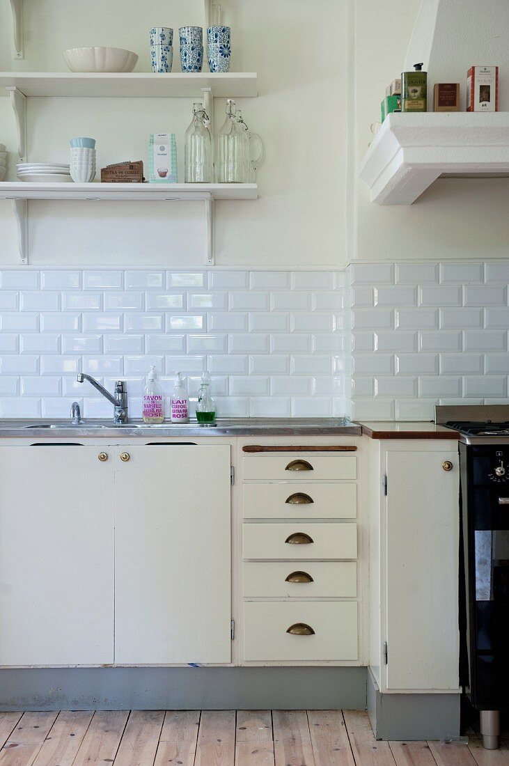 Vintage kitchen counter with base units below white-tiled splashback