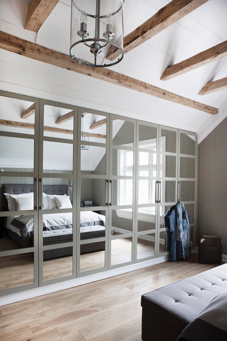 Mirrored wardrobe in attic bedroom