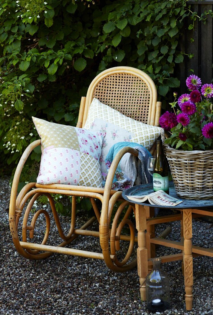 Comfortable rocking chair with patchwork cushions; vintage outdoor ambiance
