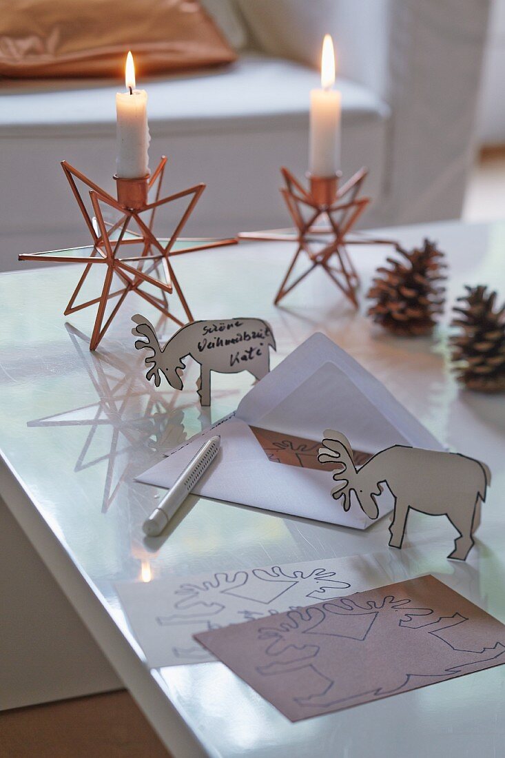 A 3D Christmas postcard with reindeer and star-shaped candles holders in the background
